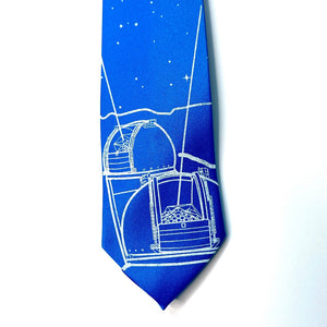 Keck Observatory Necktie, bright blue tie with observatory domes and night sky illustration in white, detail of the bottom on a white background