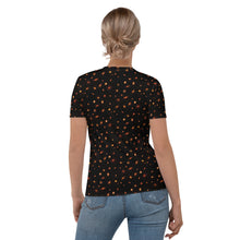 Load image into Gallery viewer, Digital mock-up front of t-shirt on model, short sleeves, black with small red and orange images of planet-forming disks at various angles.