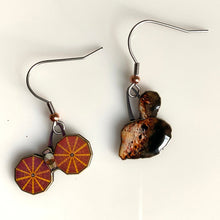 Load image into Gallery viewer, Mismatched earrngs made from upcycled paperboard, one an illustration of the Lucy mission soacecraft and the other binary asteroids in partial shadow, shown resting on a white background.