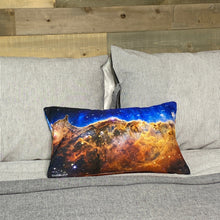 Load image into Gallery viewer, JWST Cosmic Cliffs of the Carina Nebula throw pillow on gray bedding with wood plank background
