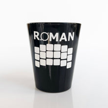 Load image into Gallery viewer, Black shot glass with &#39;ROMAN&#39; and the detector array in white vinyl, shown on a white background