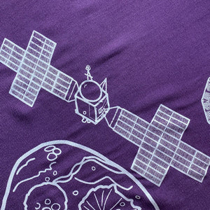 illustration detail of the Psyche spacecraft in silver ink on a purple plush-weave scarf