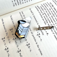 Load image into Gallery viewer, laser-cut acrylic pin in three colors (mirror, gold, and black) representing the Nancy Grace Roman Space Telescope, with the pin backing next to it shown on a page of a science textbook