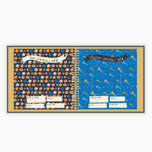 Load image into Gallery viewer, Baby memory book open to baby milestone pages with decorative planet patterns on a white background