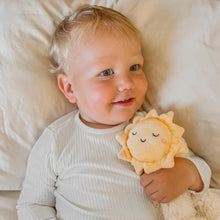 Load image into Gallery viewer, Baby holding a plush sun toy on a soft surface