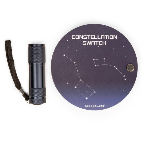 UV flashlight with lanyard and round, dark blue Constellation swatch cards on a white background