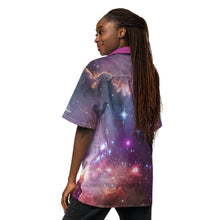 Load image into Gallery viewer, Digital mock up of a dark-skinned person with long dark braided hair wearing a short-sleeve button shirt printed with the Hubble/Spitzer/Chandra image of NGC 602 with pink collar and white buttons, seen from the left/behind.