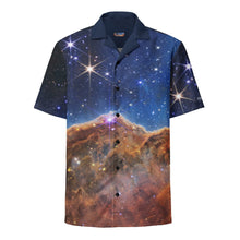 Load image into Gallery viewer, Digital mock up of a short-sleeve button shirt printed with the JWST Carina Nebula Cosmic Cliffs image with navy blue collar and black buttons, laid flat on a white background 