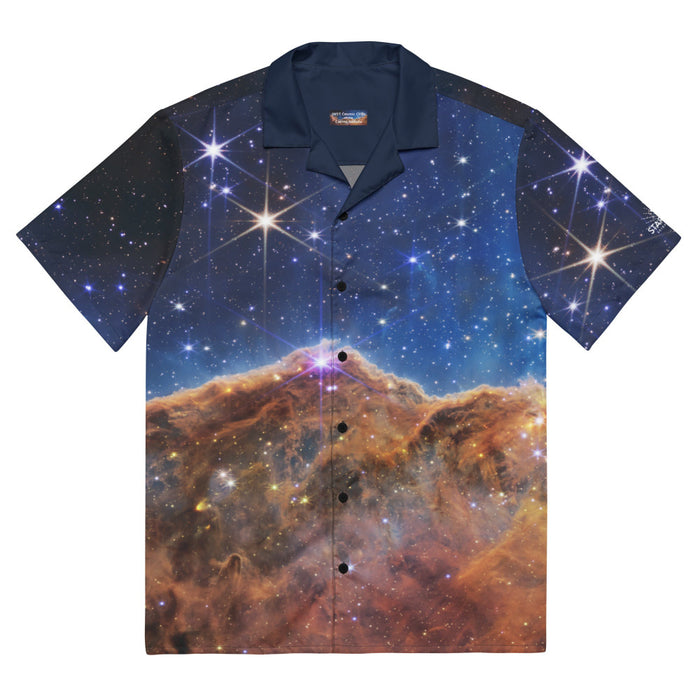 Digital mock up of a short-sleeve button shirt printed with the JWST Carina Nebula Cosmic Cliffs image with navy blue collar and black buttons, laid flat on a white background 