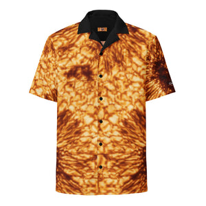Digital mock up of a short-sleeve button shirt printed with the DKIST sunspot image (yellow/orange/black) with black collar and buttons, laid flat on a white background 