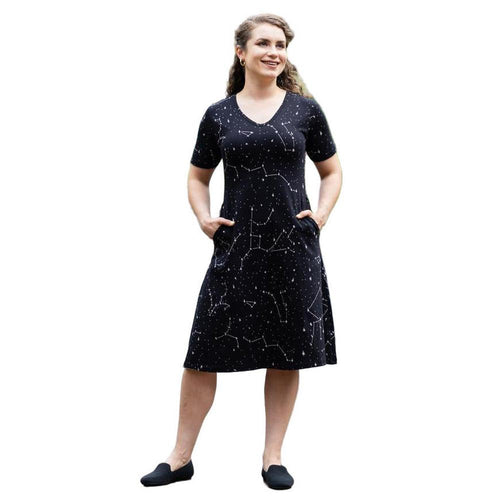 Woman wearing a black dress with white constellation patterns on a white background