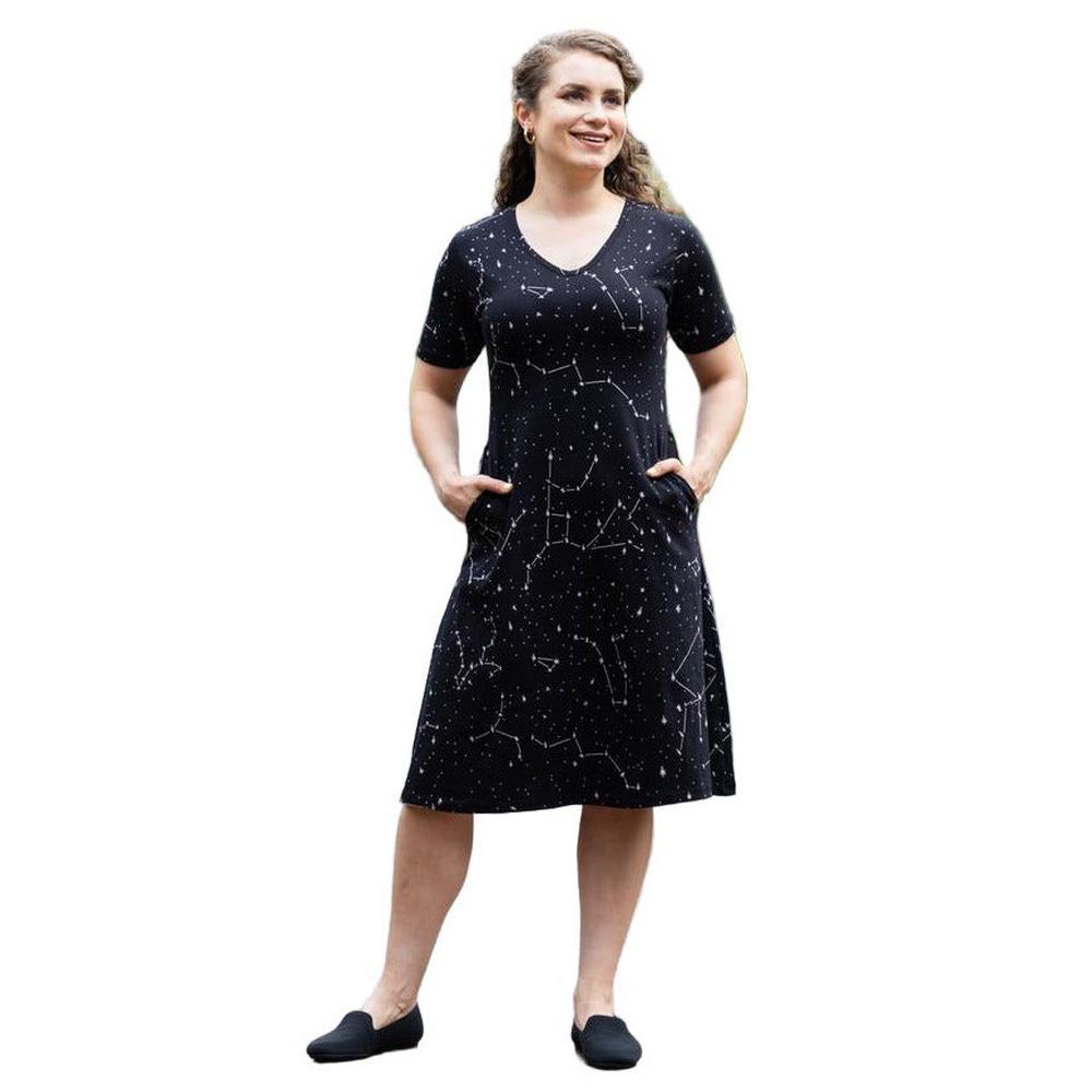 Woman wearing a black dress with white constellation patterns on a white background