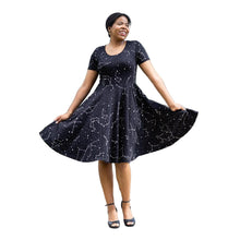 Load image into Gallery viewer, Woman wearing a black dress with white star and constellation patterns, on a white background