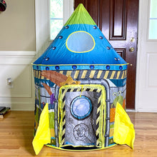 Load image into Gallery viewer, Rocketship play tent shown assembled in an interior room, with the entrance flap closed.