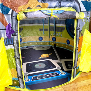 View inside the play tent from outside, with the flap opening rolled up and tied. 