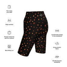 Load image into Gallery viewer, Digital mock-up of fitted shorts, black with small red and orange images of planet-forming disks at various angles, text: tear away label, high-waisted, pocket inside the belt for phone, butt-lifting cut, comfortable elastic in the waistband, 4-way stretch fabric, double-layered waistband.