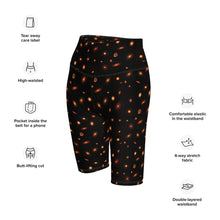 Load image into Gallery viewer, Digital mock-up of fitted shorts, black with small red and orange images of planet-forming disks at various angles, text: tear away label, high-waisted, pocket inside the belt for phone, butt-lifting cut, comfortable elastic in the waistband, 4-way stretch fabric, double-layered waistband.