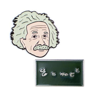 Pin with shape and image of Albert Einstein face, and rectangular black pin with equation E = mc^2 in metallic script.