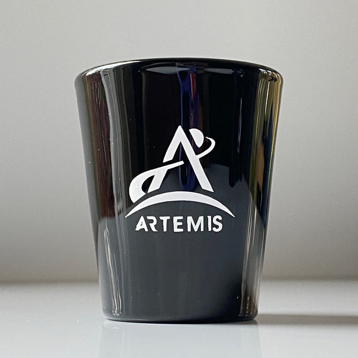 Black shot glass with white Artemis logo
